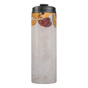 DRIED LEAVES ON WHITE CONCRETE FLOOR THERMAL TUMBLER