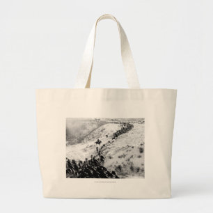 Driving cattle in the winter. large tote bag