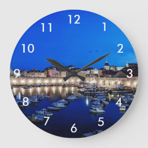 Dubrovnik harbor and walls illuminated at night large clock