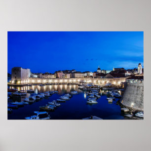 Dubrovnik harbor and walls illuminated at night poster