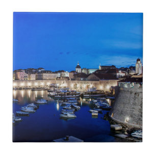 Dubrovnik harbor and walls illuminated at night tile