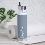 Dusty Blue Personalised Wedding Bridesmaid Water Bottle<br><div class="desc">Gift your wedding bridesmaid or maid of honour with this trendy, vacuum Insulated water bottle that features her name in white, stylised script on a dusty blue colour background designed to match your wedding colour scheme. Personalise bottle by editing and replacing name with your own as desired. Select your water...</div>