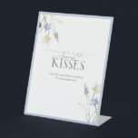 Dusty Blue Wildflower How Many Kisses Pedestal Sign<br><div class="desc">This softly framed pedestal sign adds a charming, elevated touch to your shower gamescape. With delicate watercolor florals and a dusted blue border, it sets the tone for a game that’s playful yet polished—perfect for pairing with your matching guess cards and candy jar display. Ideal for countryside venues, cottagecore-inspired gatherings,...</div>