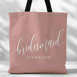 Dusty Rose Pink Bridesmaid Modern Script Tote Bag<br><div class="desc">Show your appreciation to your bridal party with this stylish dusty rose pink bridesmaid tote bag. Featuring modern script and customisable with your bridesmaid's name, this tote bag is both practical and elegant. The soft colour and chic design make it perfect for carrying wedding day essentials or everyday items. This...</div>