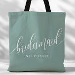 Dusty Teal Bridesmaid Modern Script Tote Bag<br><div class="desc">Show your appreciation to your bridal party with this stylish dusty teal bridesmaid tote bag. Featuring modern script and customisable with your bridesmaid's name, this tote bag is both practical and elegant. The soft colour and chic design make it perfect for carrying wedding day essentials or everyday items. This personalised...</div>