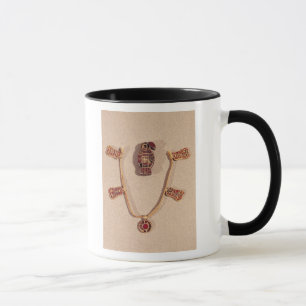 Eagle-shaped brooch and a necklace mug