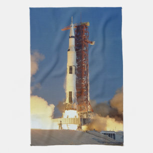Earth Shakes as Saturn V Blazes Skyward to Moon Tea Towel