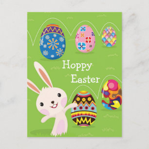 Easter bunny playful with painted eggs holiday postcard