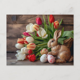 Easter bunny seated beside colorful eggs and tulip postcard