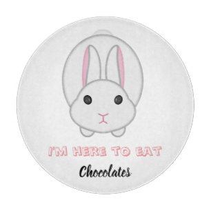 Easter bunny waiting to eat chocolates cutting board