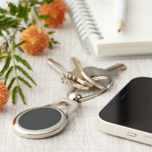 Eerie Black Oval Metal Keychain