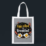 Egg-cited for Breakfast Funny Foodie Pun Design Reusable Grocery Bag<br><div class="desc">Start your morning with a smile with this playful "Egg-cited for Breakfast" design, perfect for food lovers and brunch enthusiasts alike. Featuring a charming hand-drawn style, this artwork showcases two sunny-side-up eggs alongside crispy bacon strips, all set against a whimsical backdrop of scattered seasonings and vibrant typography. The warm yellow...</div>