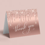 Elegant 70th Birthday Party Rose Gold Glitter Thank You Card<br><div class="desc">Chic folded thank you card for your 70th birthday party featuring "Thank You" in an elegant white calligraphy script,  a rose gold faux foil background and rose gold faux glitter. Personalise your thank you message and signature on the inside,  or leave blank for a handwritten note.</div>