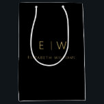 Elegant Black Gold Minimalist Monogram Name Medium Gift Bag<br><div class="desc">Present your gifts in style with our Black and Gold Modern Minimalist Monogram Name Gift Bag. This elegant bag boasts a clean and contemporary design, featuring a customisable monogram that adds a personalised touch to your gift-giving. Crafted with quality in mind, this bag is both sophisticated and minimalist, making it...</div>