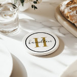 Elegant Brass Black Round Custom Monogram Initial Coaster<br><div class="desc">Elegant round personalised beverage drink coaster design features a classic custom serif monogram initial in antique gold / brass with your last name in modern black calligraphy script against a clean white background. A simple black circle frames the design. Colour scheme can be customised to coordinate perfectly with your home...</div>