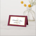 Elegant Burgundy Gold Winter Holiday Wedding Place Card<br><div class="desc">Customise this elegant winter wedding place card design with your own special touch. This festive design features the bride and groom's names and wedding date,  a starry Christmas tree and elegant gold foil frame over a burgundy background. Perfect for a winter or Christmas wedding.</div>