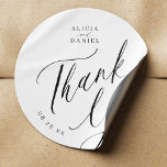 Elegant calligraphy wedding thank you favour classic round sticker<br><div class="desc">Elegant simple minimal black and white wedding favour thank you sticker featuring a classy stylish chic trendy calligraphy script.                      Easy to personalise with your details! Suitable for formal black tie neutral weddings.                 Please note that the background and text colours can be changed to match your wedding colour scheme.</div>