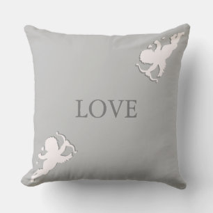 Elegant cupids in white on silver grey cushion