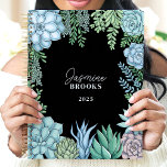 Elegant Floral Watercolor Succulent Custom Name Planner<br><div class="desc">This elegant design showcases a watercolor frame of succulents in soft green, blue, and blush hues, set against a sleek black background. The personalised name and year create a unique and refined touch, making it perfect for students, professionals, or plant enthusiasts. Ideal for organising daily tasks, journalling, or planning with...</div>