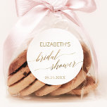 Elegant Gold Calligraphy Bridal Shower Favour Classic Round Sticker<br><div class="desc">These elegant gold calligraphy bridal shower stickers are perfect for a simple wedding shower. The neutral design features a minimalist sticker decorated with romantic and whimsical faux gold foil typography. Personalise the stickers with the name of the bride-to-be and the shower date. Please Note: This design does not feature real...</div>