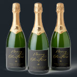 Elegant Gold Merry Christmas Script Holiday Sparkling Wine Label<br><div class="desc">Festive Merry Christmas script lettering,  holiday bottle labels. Design features,  snowflake accent and whimsical golden colour holiday typography quote on black background. Two template text lines for your message and name.</div>