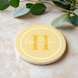 Elegant Golden Yellow Custom Monogram Initial Coaster<br><div class="desc">Elegant round personalised beverage drink coaster design features a classic custom serif monogram initial in a sunny golden marigold yellow colour with your last name in modern white calligraphy script against a light yellow coloured background. A simple white circle frames the design. Colour scheme can be customised to coordinate perfectly...</div>