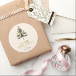 Elegant Merry Christmas Pine Tree Bow Family Classic Round Sticker<br><div class="desc">Add a festive touch to your gifts with these elegant "Merry Christmas" stickers! Featuring gold script,  a pine tree bow,  and your custom family name,  they're perfect for personalising your holiday packages with style and warmth.</div>