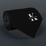 Elegant Monogram | Black White Tie<br><div class="desc">An elegant necktie featuring a bold white monogram across a black background. Atop this monogram sits your first or last name spelled out in all capitals. If you prefer a bolder look for the personal name inside of the large letter you can do the following: Use the customize/ edit function...</div>