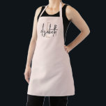 Elegant Monogram Blush Pink Modern  Apron<br><div class="desc">Make a stylish statement with this stunning monogram name pink, black and gold modern apron. Printed with your own name in a unique black script font with a gold initial, this apron offers a unique look that will make you look great while keeping your clothes protected. Whether you are a...</div>