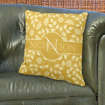 Elegant Monogram Leaves Daisies Custom Name Gold Cushion<br><div class="desc">This design features elegant monogram and custom name script with pastel yellow daisies and leaves artwork over a gold background on both sides of this throw pillow. Personalize the initial letter and name, remove one or the other or click customize to select a font style, size, and color you like....</div>
