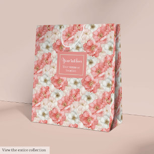 Elegant pink flowers and gold monogram gift bag