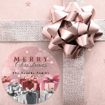 Elegant Pink Silver Wrapped Gift Boxes Christmas Classic Round Sticker<br><div class="desc">Add a touch of sparkle to your holiday season with this customisable Christmas sticker! Set against a glittery pink backdrop, the sticker features the festive greeting "Merry Christmas", a combination of a red serif and a elegant black cursive font. Personalise it with your family name, like "The Brooks Family" shown...</div>