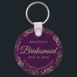 Elegant Plum Purple & Gold Bridesmaid Wedding Gift Key Ring<br><div class="desc">These keychains are designed to give as favours to bridesmaids in your wedding party. They feature a simple yet elegant design with a deep plum purple coloured background, gold script lettering, and a lacy golden faux foil floral border. The text says "Bridesmaid" with space for her name, the names of...</div>