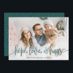 Elegant Script Full Photo Hope Love Hugs Green Holiday Card<br><div class="desc">Send love this season to your family and friends with these modern styled cards by Orabella Prints. Elegant text overlay reads, "hope, love, & hugs" in dark teal green over a white gradient overlay on the bottom of the card. The back features tiny white snow dots over a teal green...</div>