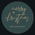 Elegant Script Merry Christmas Gold Star Dark Teal Classic Round Sticker<br><div class="desc">These stylish Christmas holiday stickers feature elegant typography reading,  "Merry Christmas" in faux gold foil,  along with a little star accent. The background colour can be customised to any colour you'd like! Great for use as envelope seals,  party favour labels,  or gift sticker labels!</div>