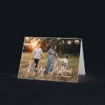 Elegant Script Photo Modern Christmas Holiday Card<br><div class="desc">Modern photo Christmas card featuring a simple and minimal design with the greeting "Merry Christmas" in an elegant white script along with your family name.  The inside has a photo collage consisting of six square pictures.</div>