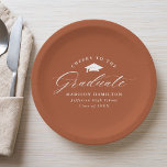 Elegant Script Terracotta Cheers to the Graduate Paper Plate<br><div class="desc">Elegant graduation paper plates featuring a graduation cap with the phrase "Cheers to the Graduate" in a white calligraphy script on a terracotta background. Personalise the modern graduation paper plates with the graduate's name, school name, and graduation year. The simple graduation plates are perfect to use for your high school...</div>