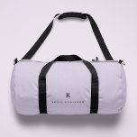 Elegant Sophisticated Classic Monogram Lilac Duffle Bag<br><div class="desc">An elegant mininalist design with a classic typography initial and name in black on a pastel lilac lavender purple background. The perfect personalised accessory which is easy to customise for any occasion!</div>