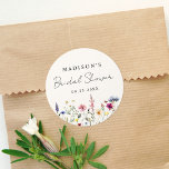 Elegant Wildflower Meadow Cream Bridal Shower Classic Round Sticker<br><div class="desc">Elegant floral bridal shower stickers featuring a bottom border of watercolor wildflowers and foliage in shades of pink, yellow, purple, blue, and green on a cream background. Personalise the wildflower bridal shower stickers with the bride-to-be's name and the date. The personalised wildflower stickers are perfect for spring and summer bridal...</div>