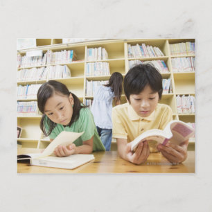 Elementary school students reading a book postcard