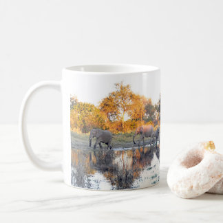 Elephant herd at waterhole in afternoon light coffee mug