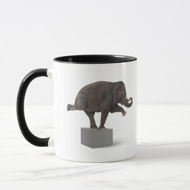 Elephant performing trick on box mug (Left)