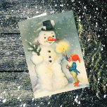 Elf and Snowman Vintage Christmas Card<br><div class="desc">Here's a cute Victorian era Christmas card with the image of one of Santa's elves holding a lighted candle up for a snowman to see. Fun to celebrate the Holidays the old fashioned way! Easily customise the inside message to suit your taste, or leave as is. For hundreds of vintage...</div>