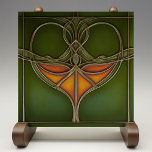 Emerald Grace Art Nouveau Tile<br><div class="desc">Infuse your home with the timeless elegance of the "Emerald Grace Art Nouveau Ceramic Tile, " a stunning piece that embodies the fluidity and organic beauty of the Art Nouveau movement. This ceramic tile, printed by Zazzle, features a captivating design with flowing lines and a central motif in rich shades...</div>