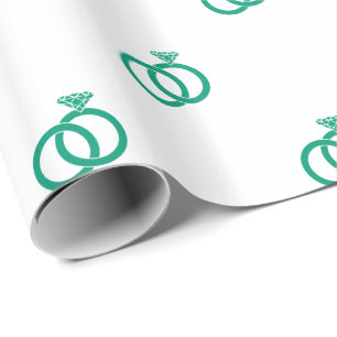 Emerald Green Wedding Rings on White Wrapping Paper