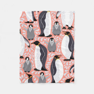 Emperor penguins and their cubs on a pink patterne fleece blanket