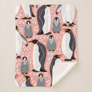 Emperor penguins and their cubs on a pink patterne sherpa blanket