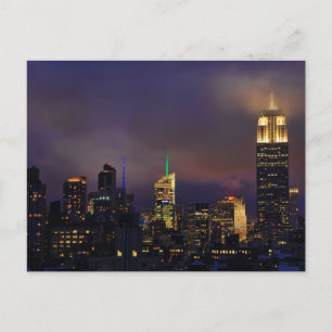 Empire State Building glows in clouds and fog Postcard