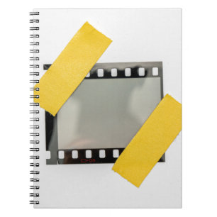 Empty 35mm film frame, yellow strips. notebook