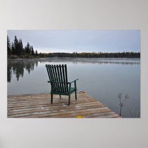 Empty chair on lake deck poster
